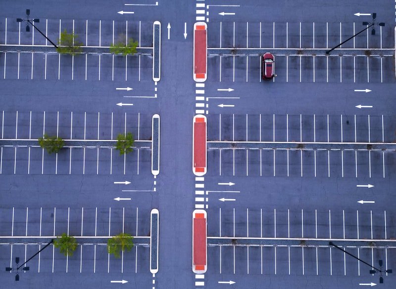 An overhead view of a parking lot with cars