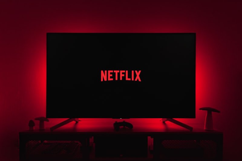 a television with the netflix logo lit up in the dark