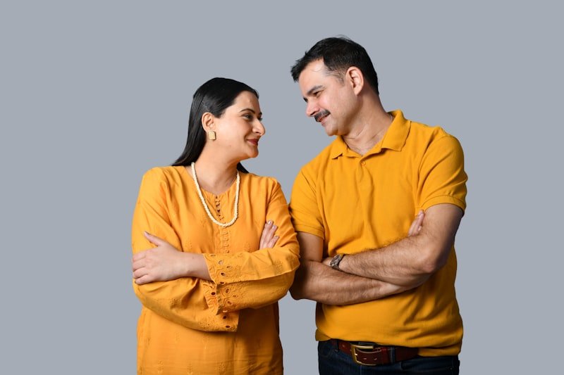 a man and a woman standing next to each other and smiling