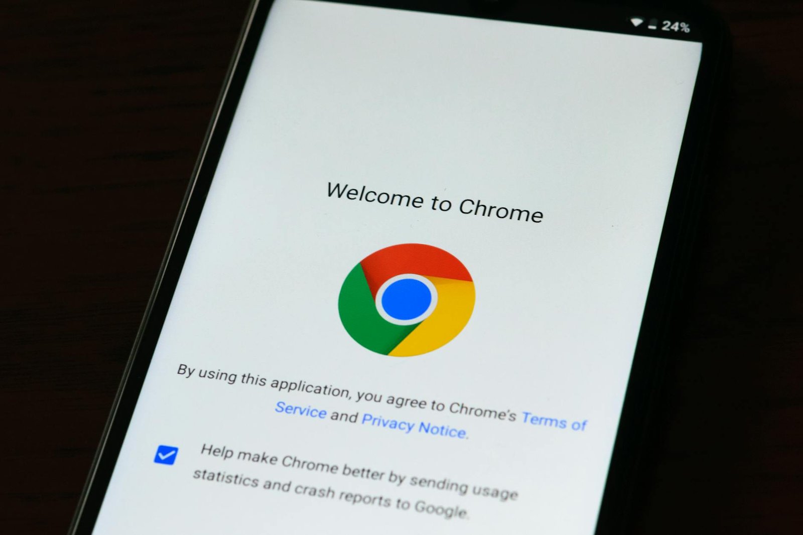 Close-up of smartphone displaying Google Chrome's welcome page and logo.