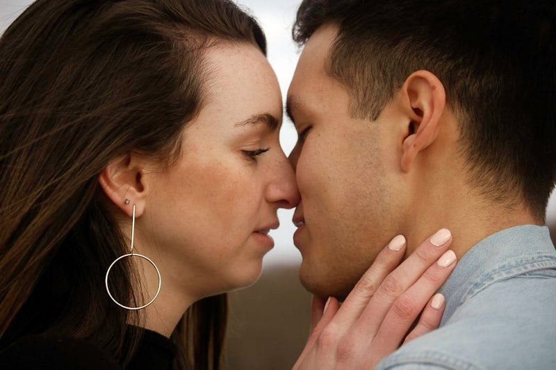 man and woman kissing each other