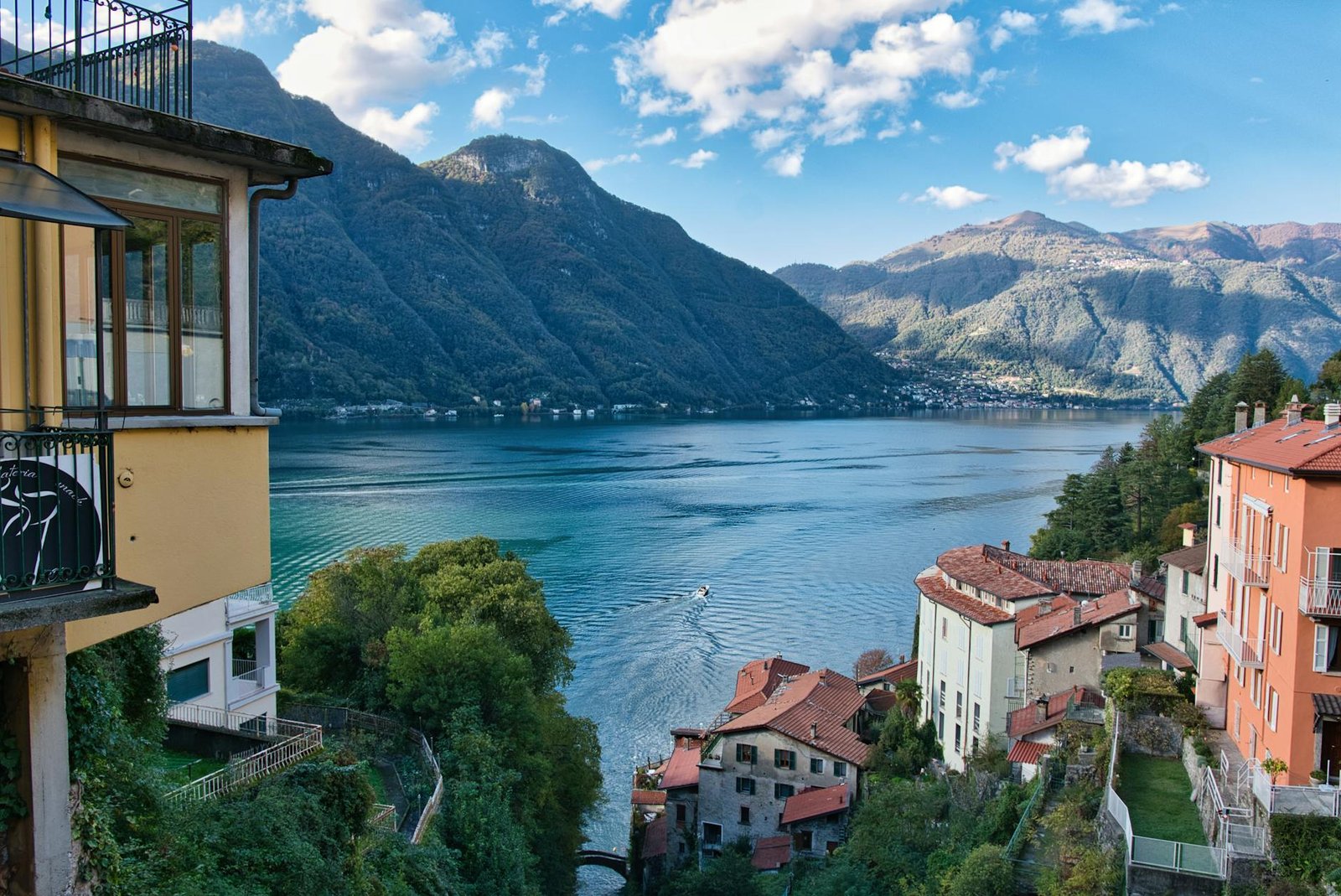 Stunning view of Lake Como with hillside Italian village and mountains in Lombardy, Italy.