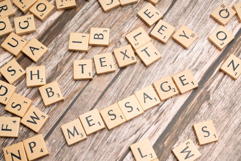 a close up of scrabble letters on a wooden surface