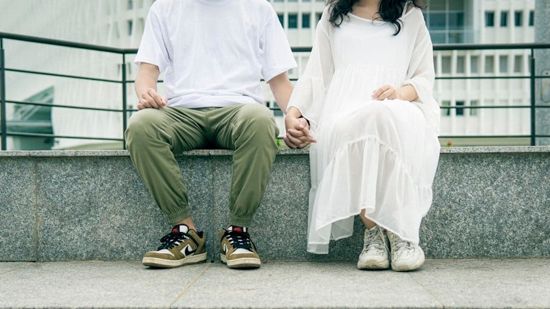 man in white dress shirt sitting on white bench