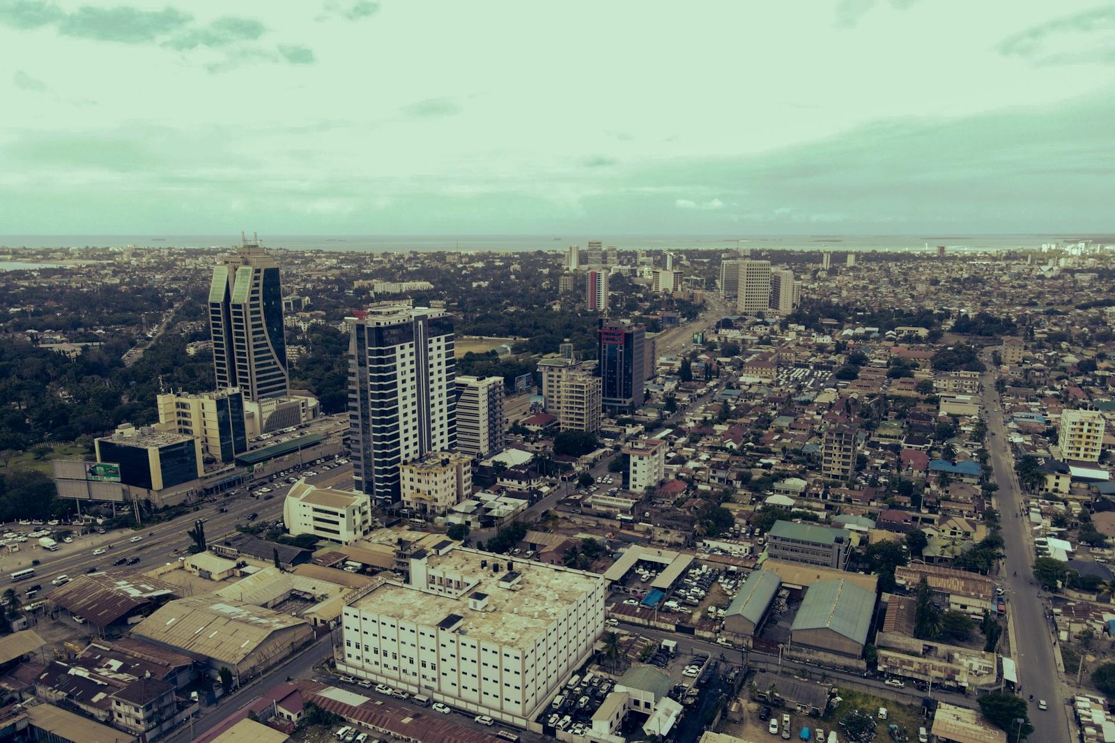 Explore the dynamic skyline of Dar es Salaam, Tanzania in this aerial cityscape view.
