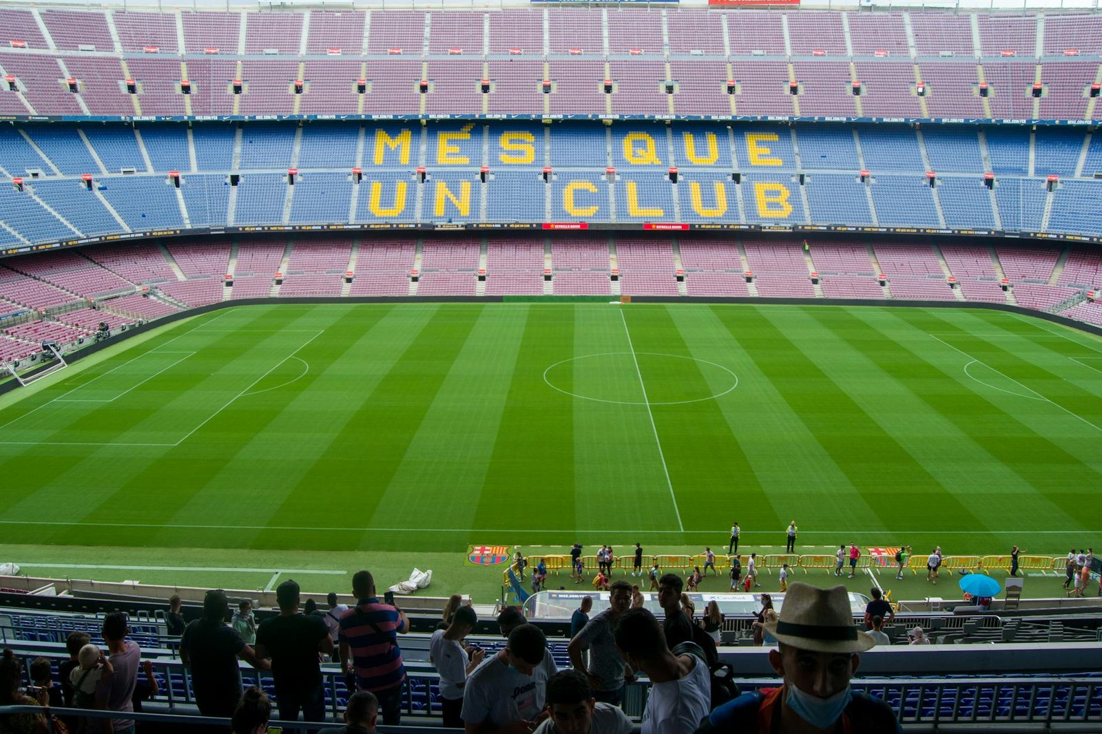 Aerial view of Camp Nou Stadium in Barcelona, showcasing the iconic 'Més Que Un Club' seating in daylight.