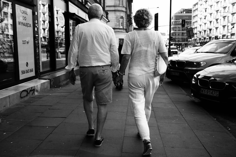 a man and a woman walking down a sidewalk