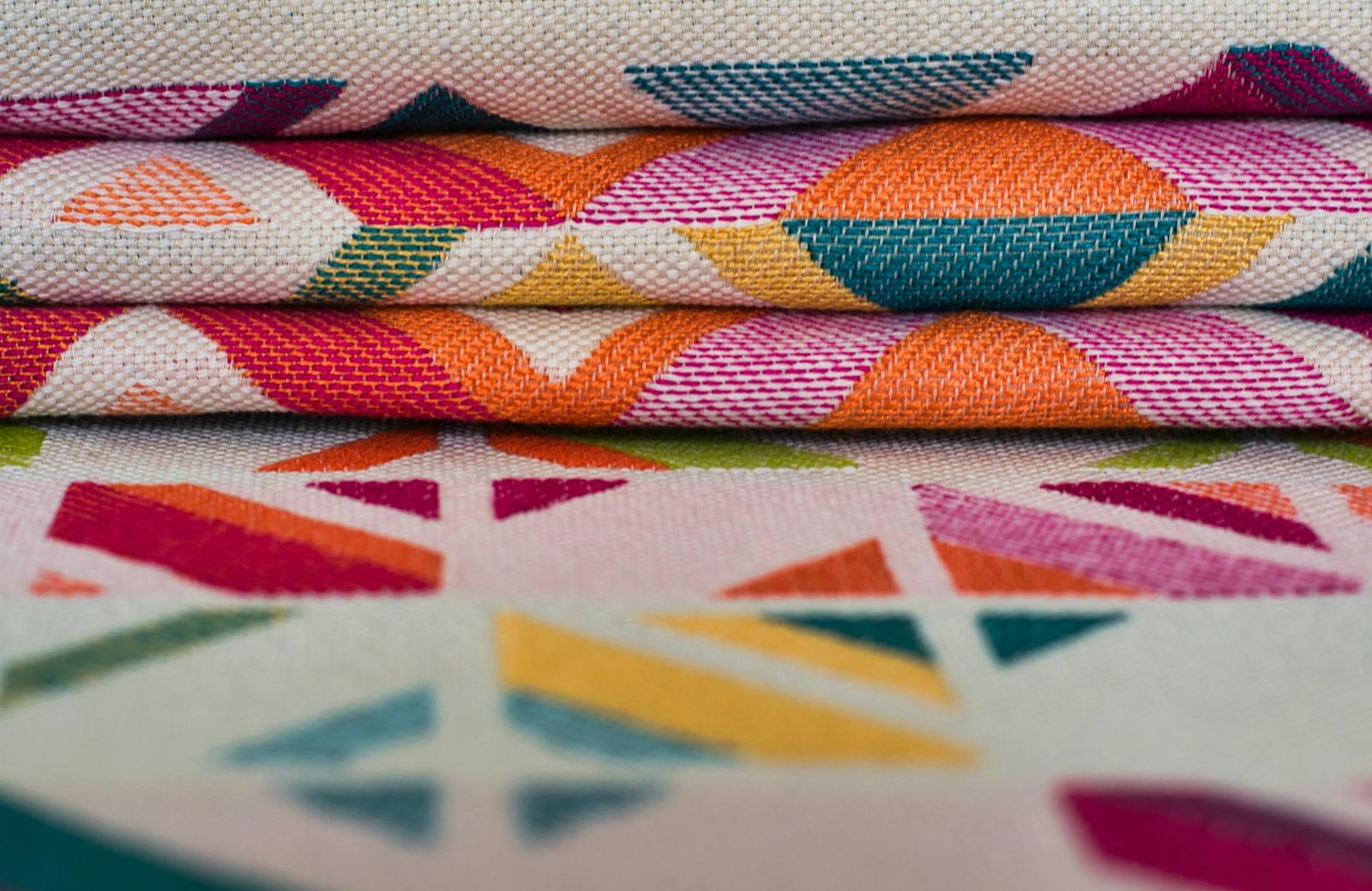 Brightly colored textiles with geometric patterns, ideal for creative projects or vibrant decor.