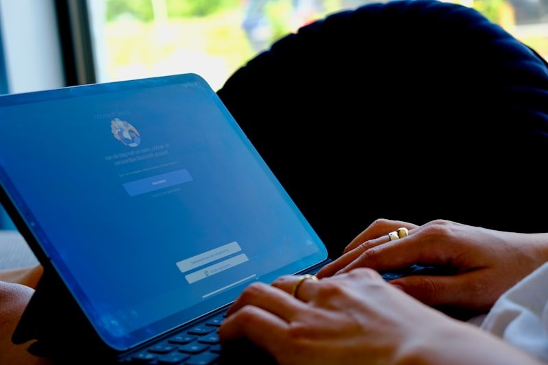 person using blue asus laptop