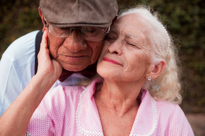 An older couple is embracing each other